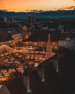 a christmas tree is lit up in the middle of a city