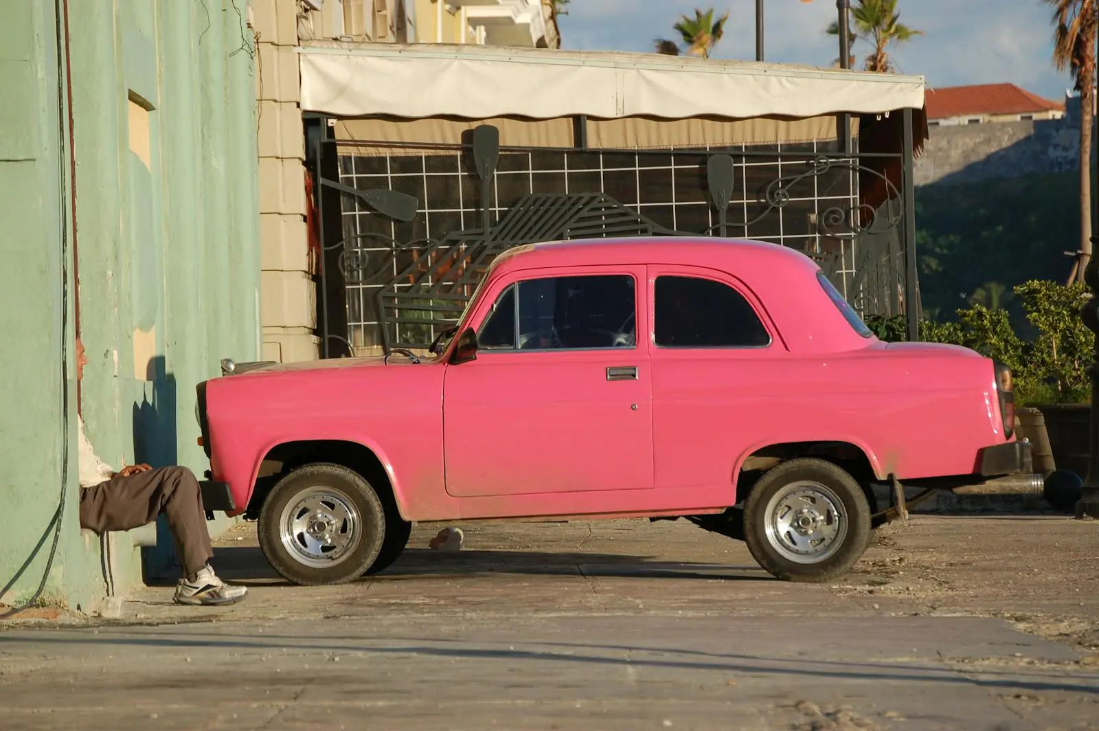 Photo by Chus García Classic pink car against an urban backdrop in Havana, Cuba, showcasing vintage charm.