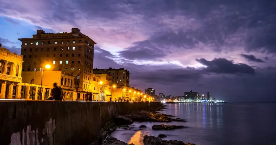 lighted post lamps near sea during night