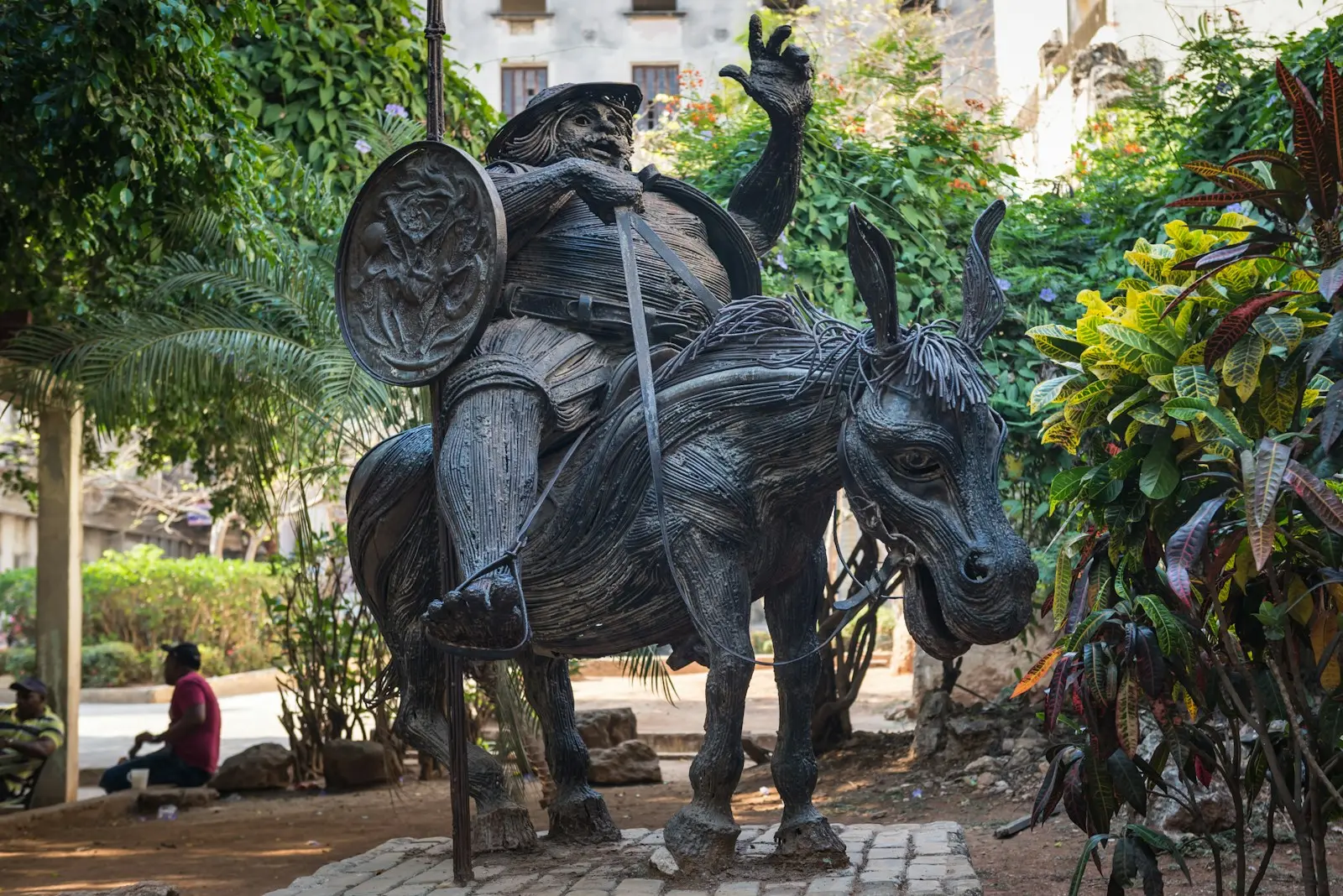 a statue of a man riding on the back of a bull